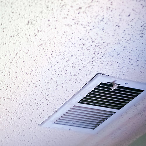 A popcorn ceiling with a vent